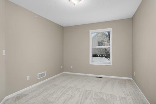 Additional upper-level bedroom offering comfortable living space and easy access to the full hallway bathroom.