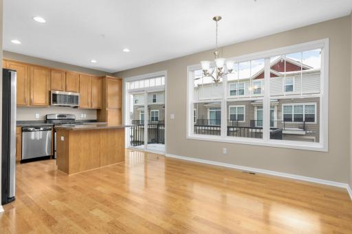 Dining area with plenty of space for hosting, conveniently situated between the kitchen and family room for easy entertaining.
