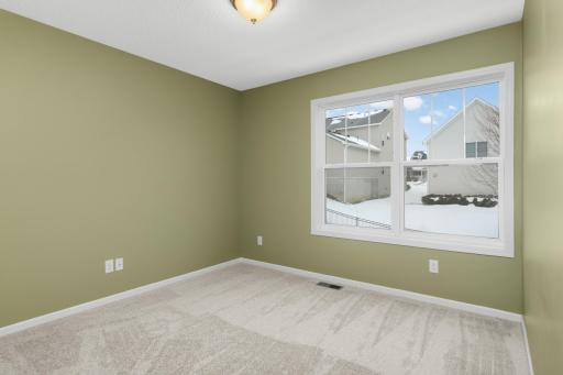 Well-sized secondary bedroom with neutral finishes and flexible use for guests, home office, or hobby space.