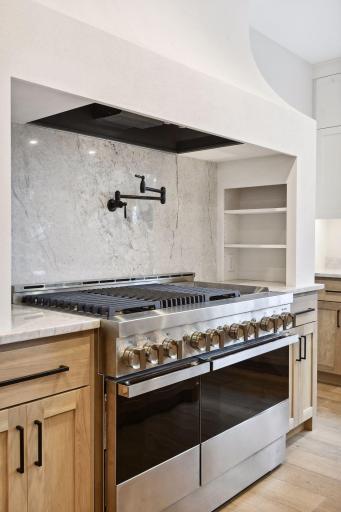 Jenn-Aire 48" stove w/potfiller. Side shelving for spices