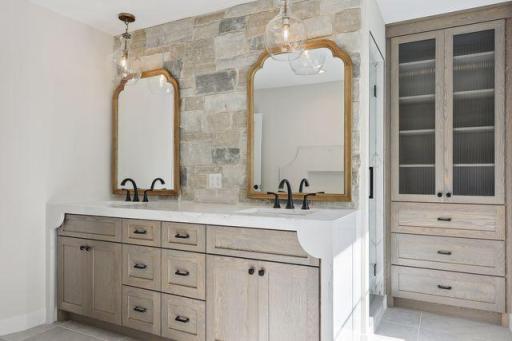 Primary waterfall vanity with reeded linen closet.jpg