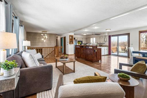 Expansive and open living, dining, and kitchen areas are filled with light from both sides of the home.