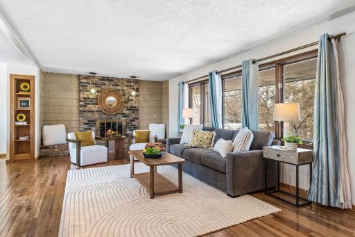 Vintage details include a brick wood burning fireplace and built-in shelving.