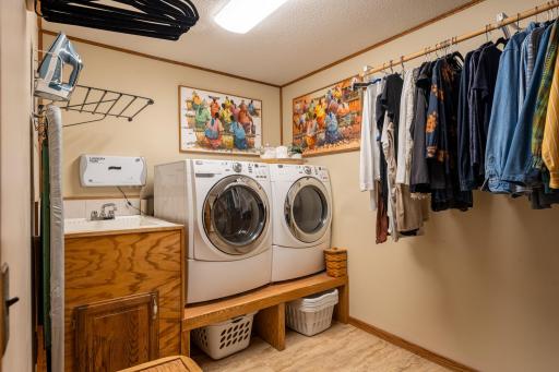 Laundry room with utility sink and it serves as a second closet.