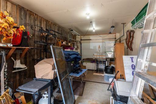 The third garage stall is insulated and has an overhead door which opens from the north side of the garage and a service door on the south side of the garage.