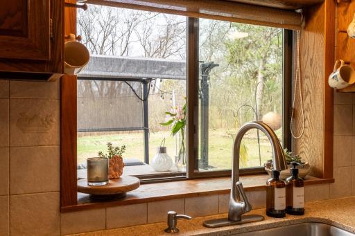 One unique feature is the kitchen window serves as a pass through for convenient access to the outdoor living areas when entertaining.