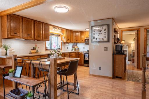 The kitchen has oak cabinets, solid surface countertop, tile backsplash and top quality appliances.