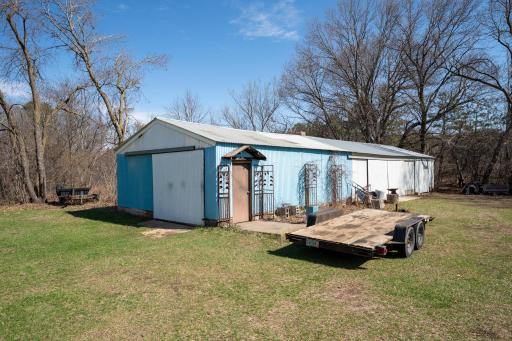 Car enthusiasts and hobbyists will love the 22' x 79' shed. One unique feature is a hinged wall that encloses the heated area. It has electricity and a wood stove for heat. There is a concrete floor except for a 16.5x22 section.