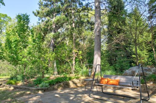 The paver patio area provides an additional outdoor living area and it includes a swing area and has easy to maintain native plants.