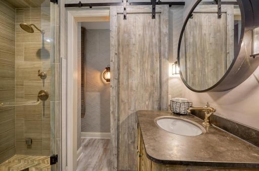 Well-appointed bath with step-in steam shower and a dedicated toilet room.