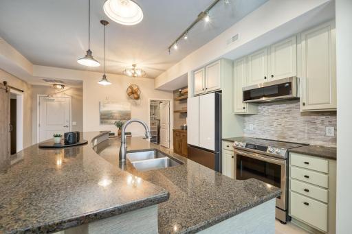 Large kitchen island offers extra seating and plenty of workspace.
