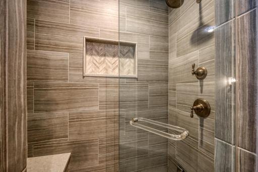 Gorgeous steam shower with custom tile detailing and built-in seat, creating a relaxing, spa-inspired retreat.