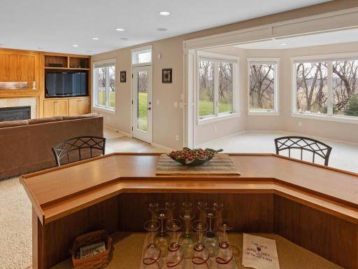 View from the wet bar into the family room and sun filled game room area...ideal for billiards, game table, etc.