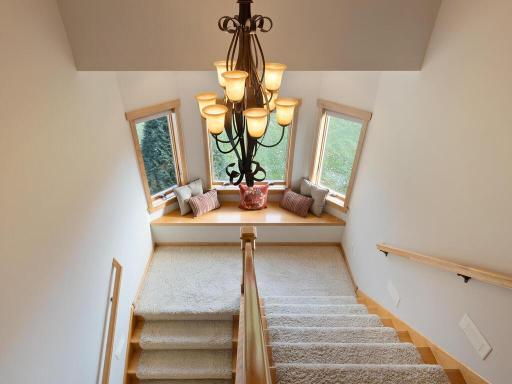 Staircase up features a built-in window seat and bayed windows for extra light.