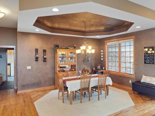 Spacious formal dining also to the front of the home offers a special ceiling with chandelier and carpet insert.