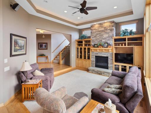 Sunken great room offers tray vaulted ceiling, cozy gas fireplace with hearth and built-ins and fabulous windows!