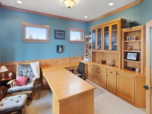 Wonderful home office to the front of the home features French doors, wainscot and extensive built-ins.