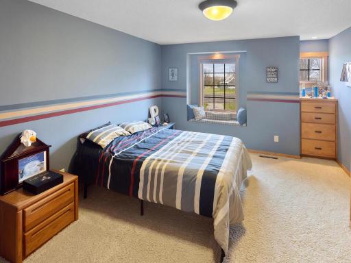 Bedroom 2 of 3 in the upper level featuring charming window seat and built-in dresser.