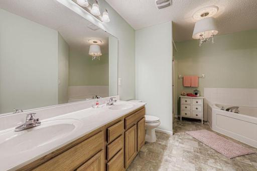 Private Owners Bath with dual sinks, shower and a jetted tub.