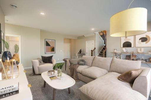 Expansive great room layout designed for comfortable gathering, anchored by wide windows and warm natural light.