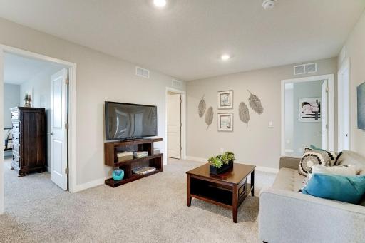 Versatile loft space located in the very center of the upstairs bedrooms. Great for gathering and hanging out! Model picture shown. Colors and finishes may vary.