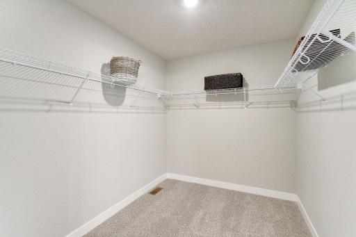 Huge primary closet for the main bedroom. Model picture shown. Colors and finishes may vary.