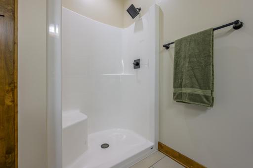 The primary ensuite bathroom features a spacious stand-up shower.