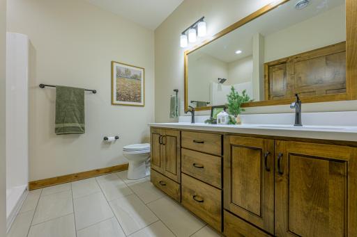 The private primary ensuite bathroom features double sinks and a large linen cabinet for superior organization.