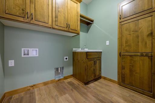 The dedicated laundry room features a sink, a broom closet, and laundry hookups.