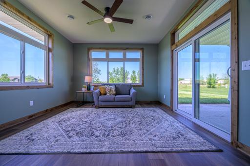 The sunroom features a patio door that leads out to the covered back patio.