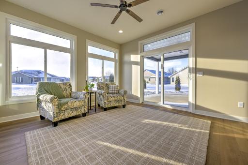 Enjoy seamless indoor-outdoor living with a spacious sunroom with patio doors that lead out to the covered back patio.