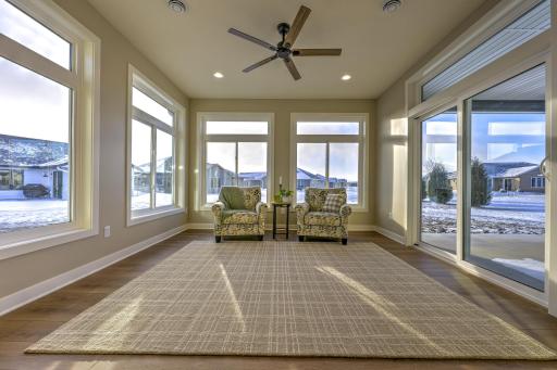 Enjoy seamless indoor-outdoor living with a spacious sunroom with patio doors that lead out to the covered back patio.