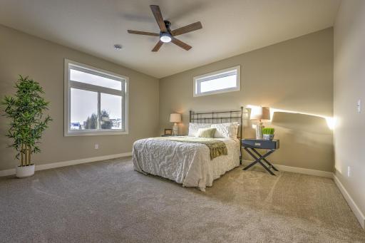 The spacious primary bedroom features a private ensuite bathroom and a walk-in closet.