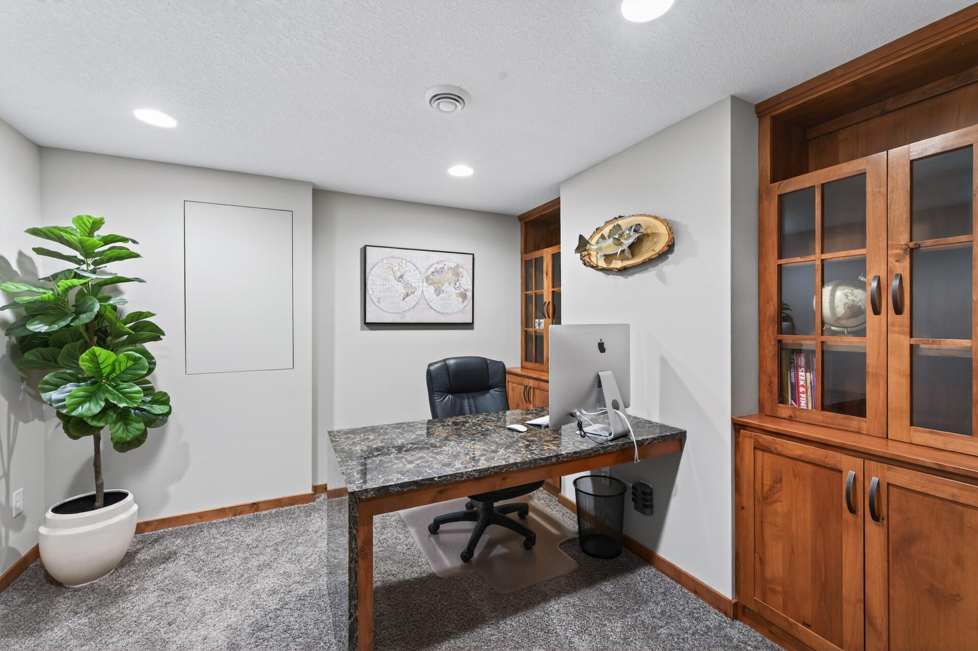 Home office space with custom- built in desk and bookcases