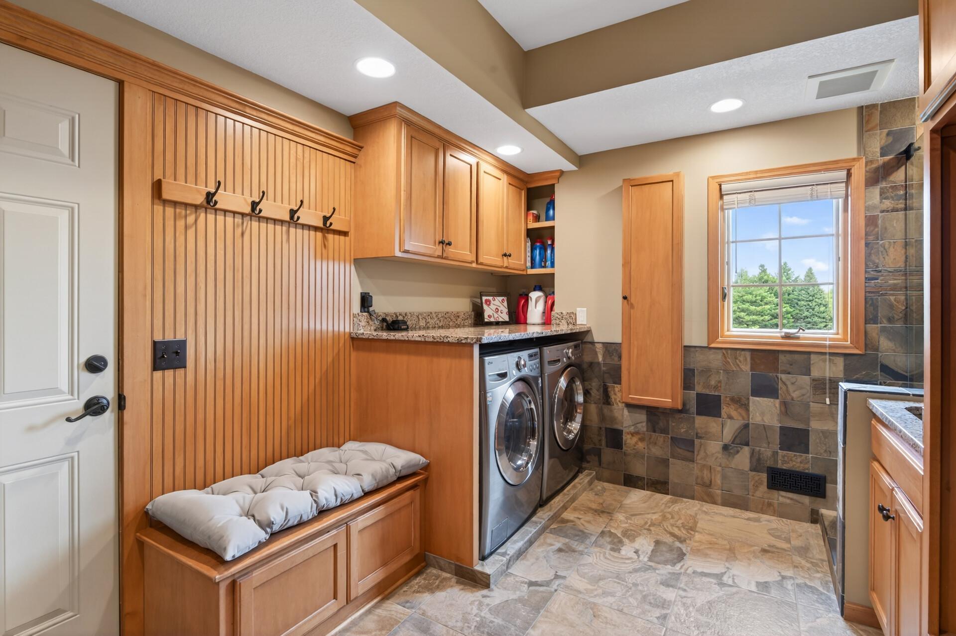 Laundry/mudroom space with maple cabinets