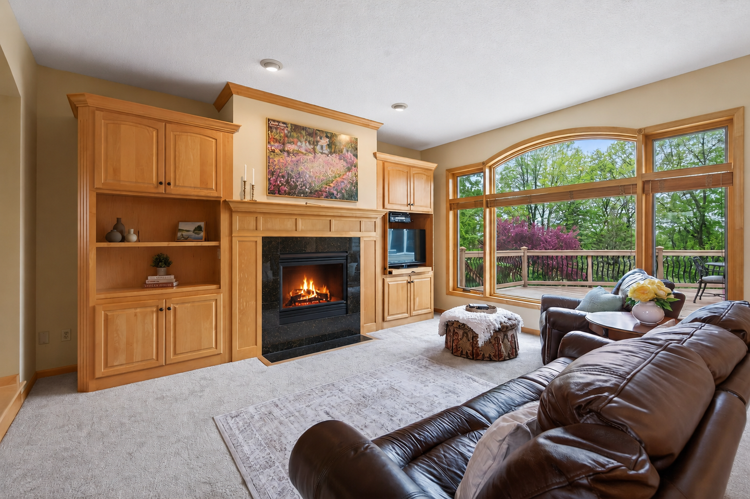 Main level living room with huge windows and gas fireplace