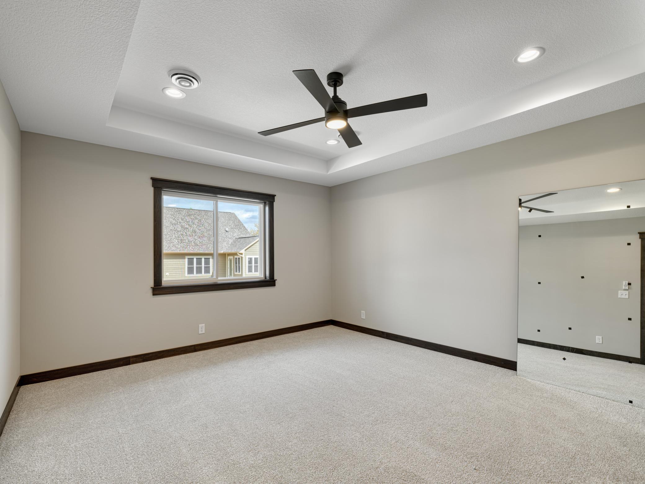 13 - 234 Primary Bedroom - tray ceiling and on-trend ceiling fan complete this beautiful primary bedroom