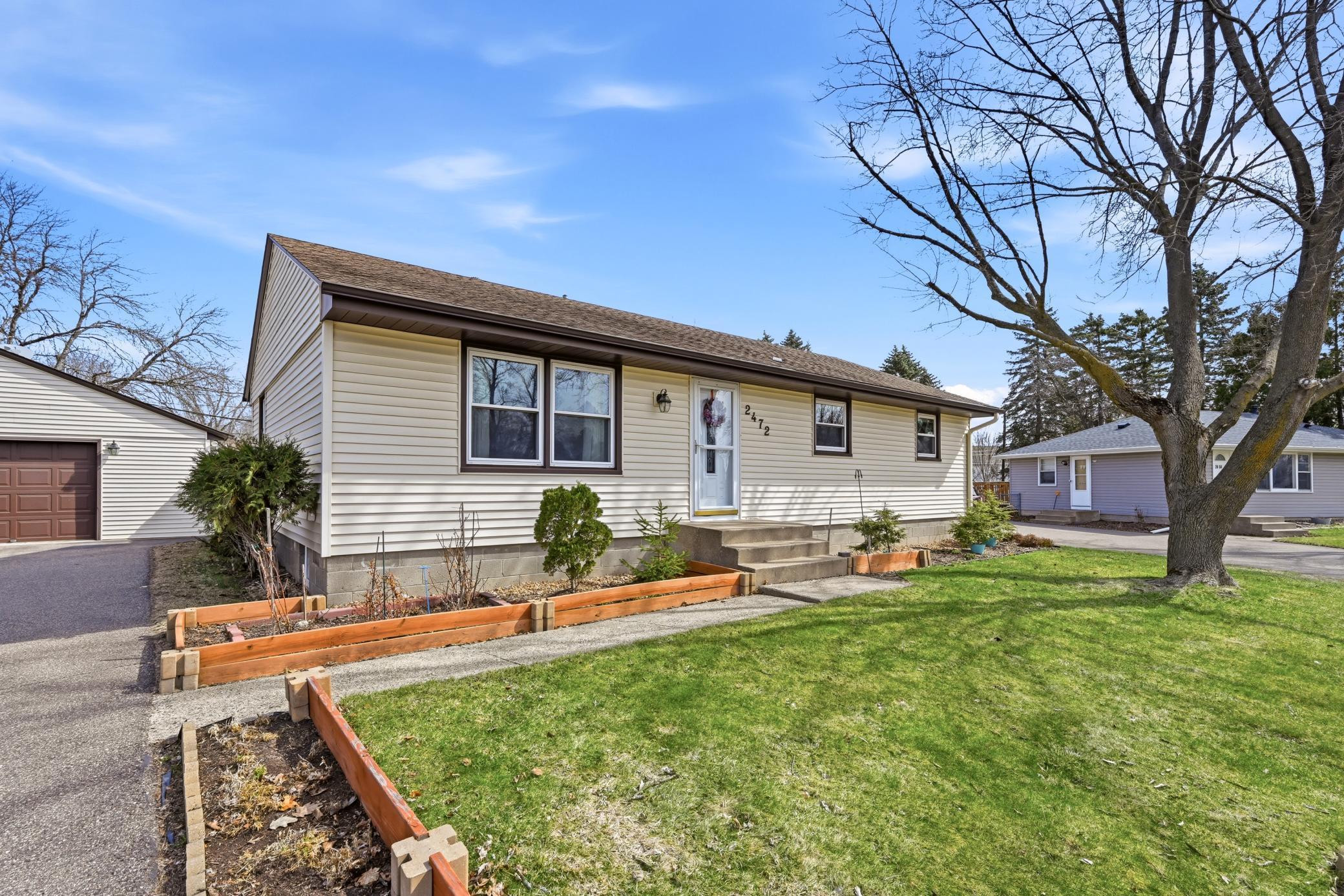 The well-maintained front yard offers great curb appeal with established garden beds ready for your personal touch.