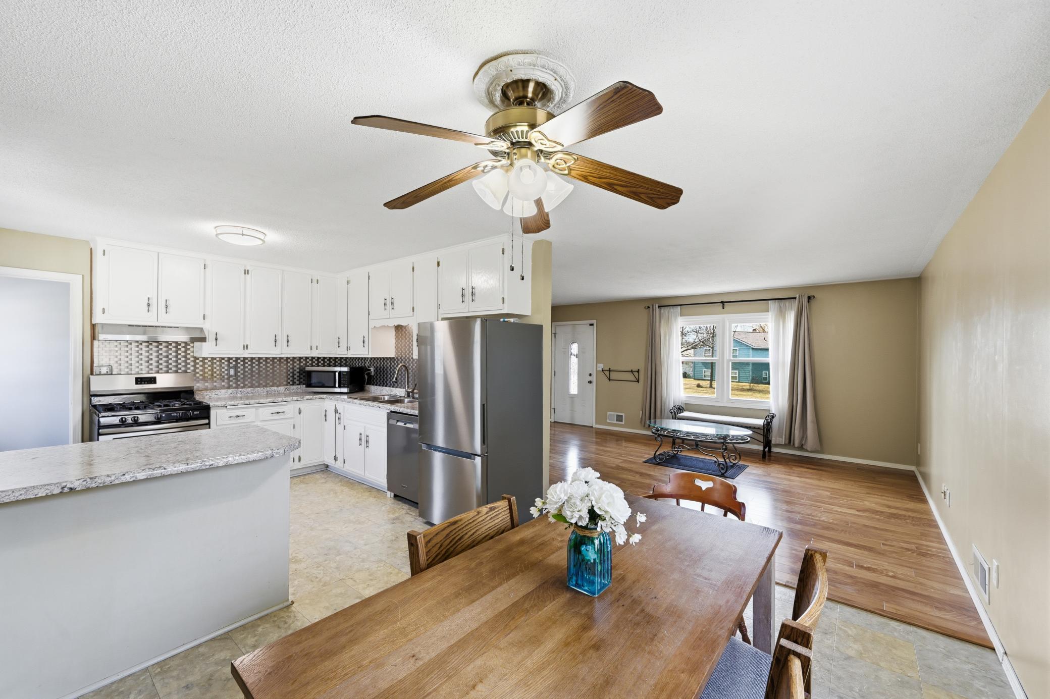 A modern kitchen setup featuring sleek stainless steel appliances, crisp white cabinetry, and an efficient U-shaped design.