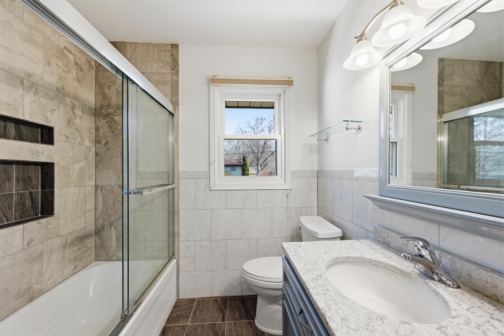 Updated full bathroom with linen closet for extra storage.