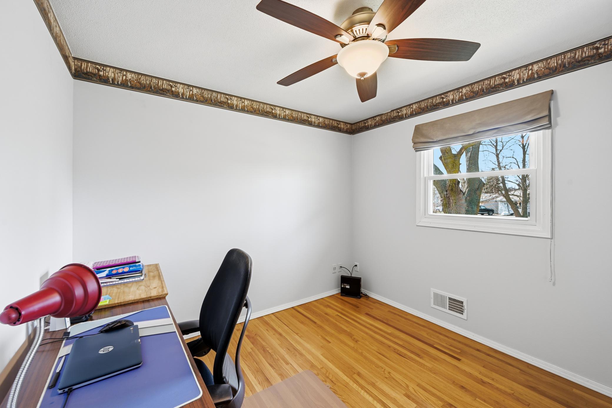 One of the 3 main level bedrooms with hardwood floors and large closet.