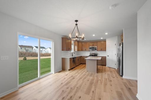 Dining room and kitchen of similar home. Selections and finishes will vary.