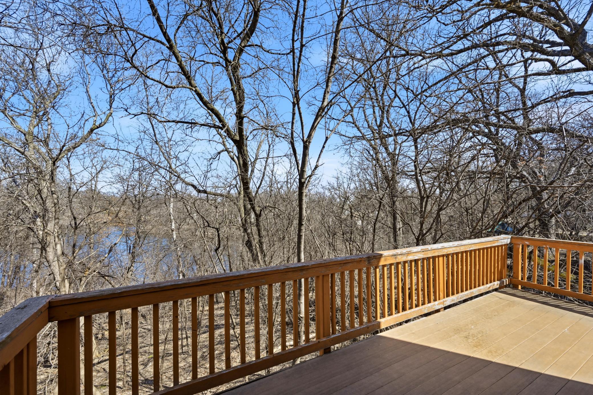 Large private deck off the main level, perfect for morning coffee or summer BBQs while enjoying the wooded scenery.
