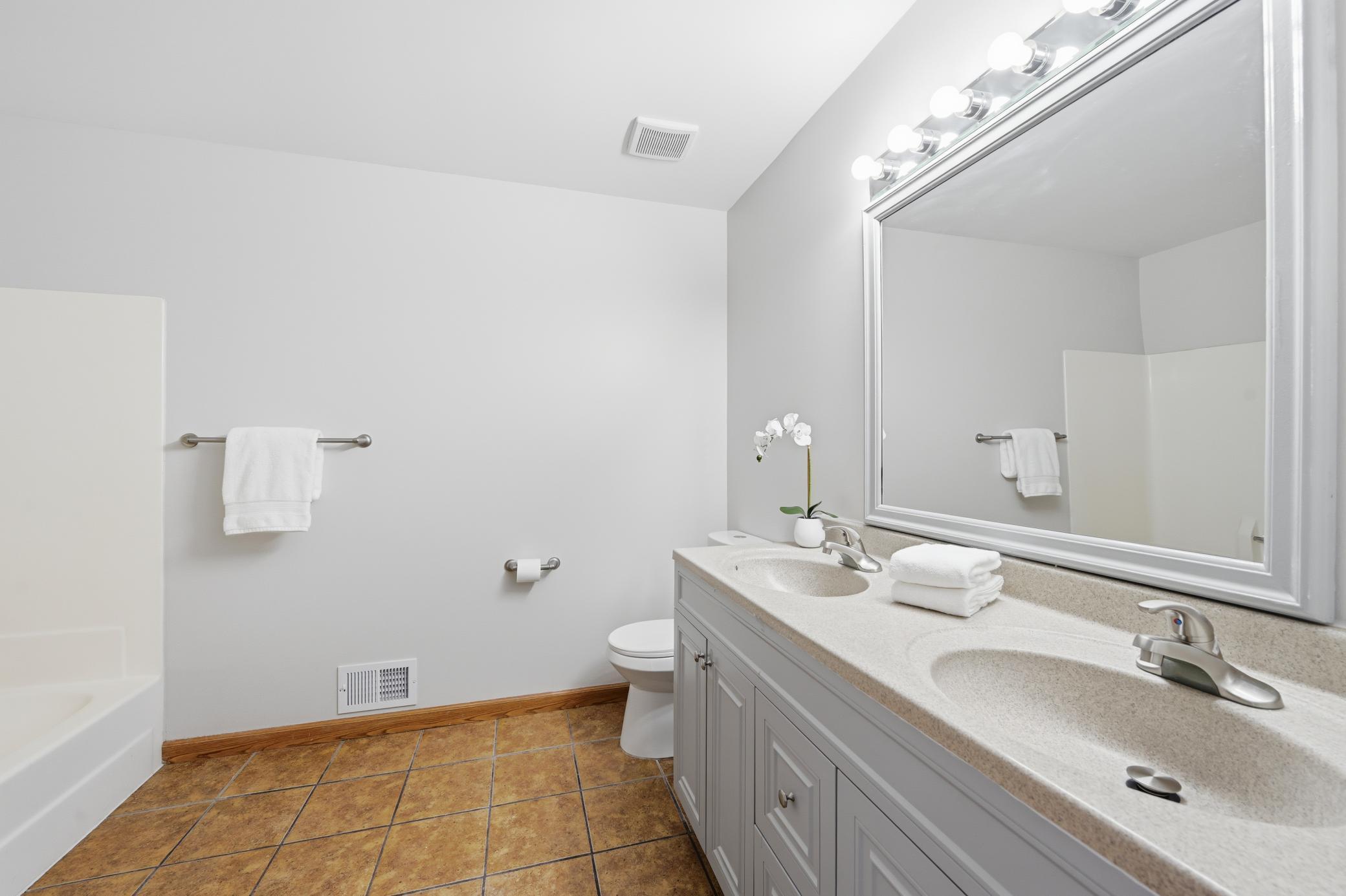Full upper-level bathroom with updated fixtures and a clean, modern aesthetic. Washer and dryer hook-up available if buyer wants to have laundry on the same level as the bedrooms.
