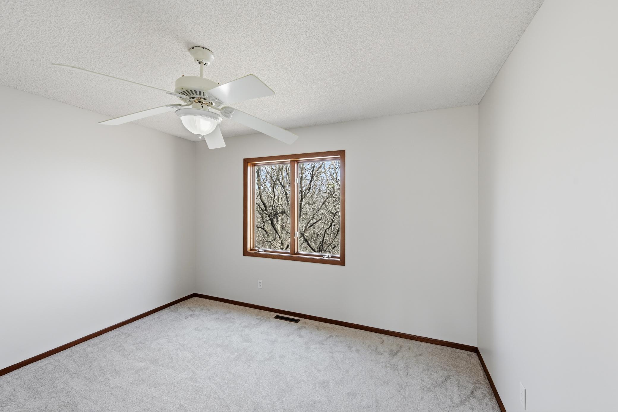 Second upper level bedroom with pretty wooded views.