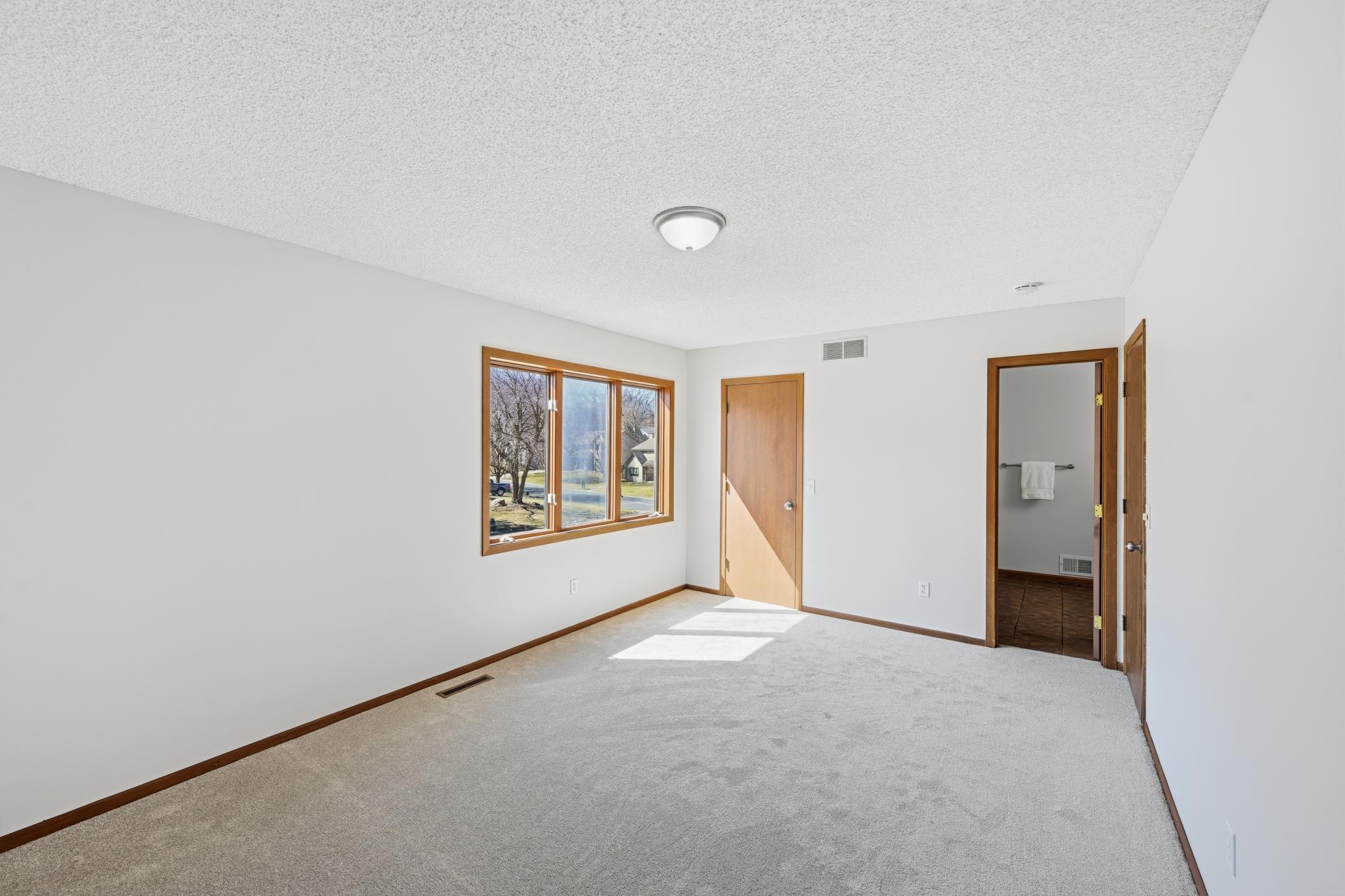 Spacious primary with large walk-in closet and direct access to the full bathroom.