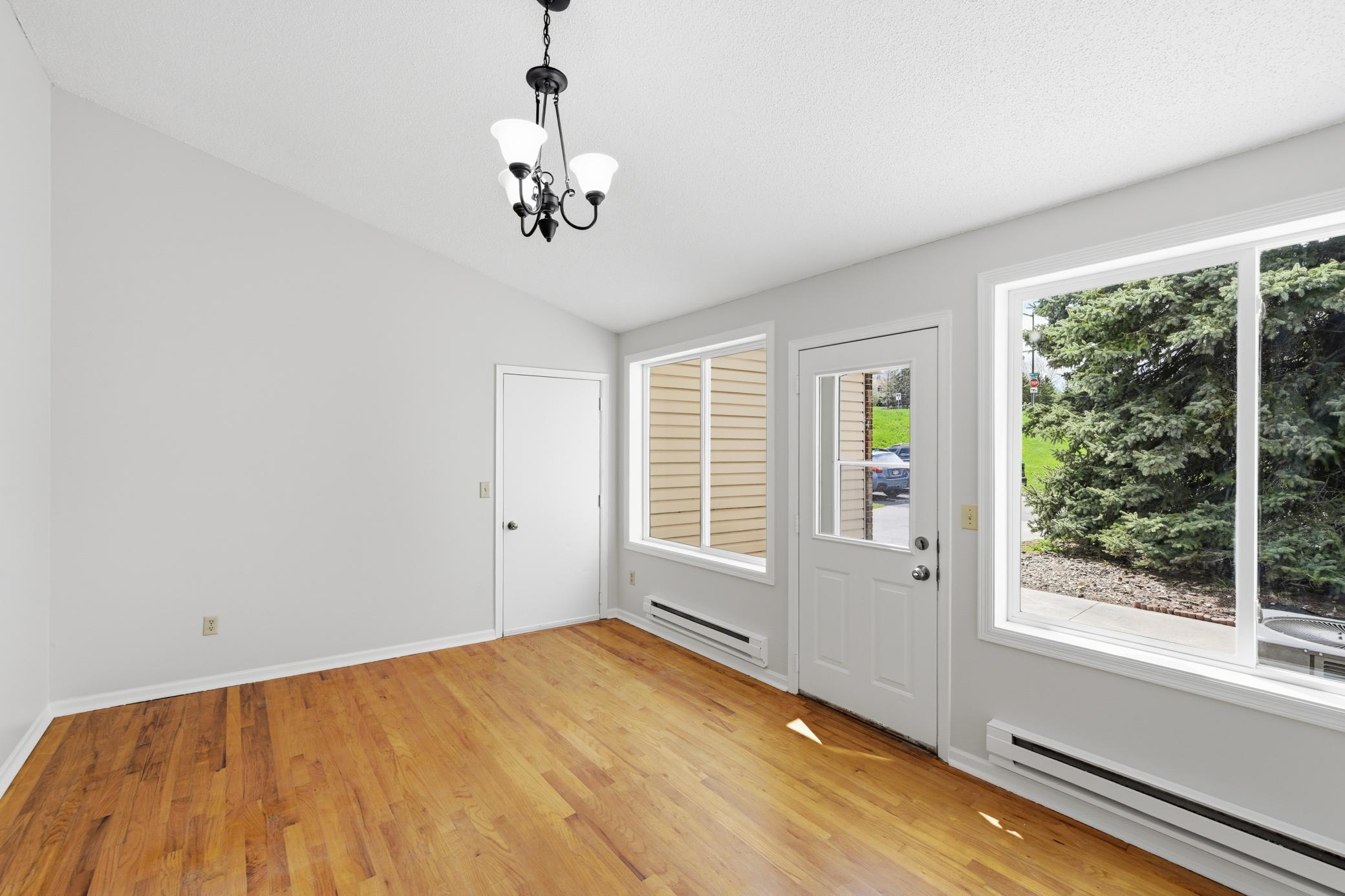 The family room connects the garage to the kitchen and has a vaulted ceiling with large windows.