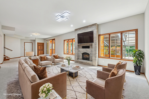 Family room boasts a wood-burning fireplace with white brick surround, an inviting spot to cozy up - as well as a flexible space thatâs great for a gaming area. There is plenty of room for your favorite billiard games.
*Digital fire effect added*