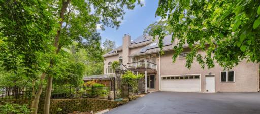 From the back of the house, youâll see part of the inviting patio area and retaining wall and the elevated deck with additional patio space below. Also featured is an impressive additional three-car garage.