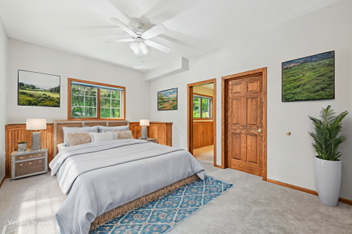 The guest room is quietly tucked away on the lower level, offering a peaceful retreat for your visitors. It features a walk-in closet and a private en-suite bathroom for added convenience.